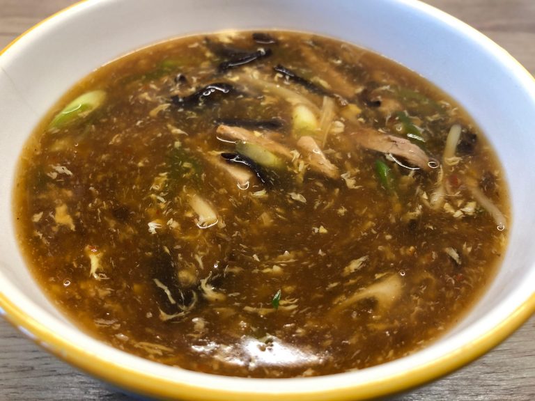Chinese takeaway style hot & sour soup in a serving bowl.