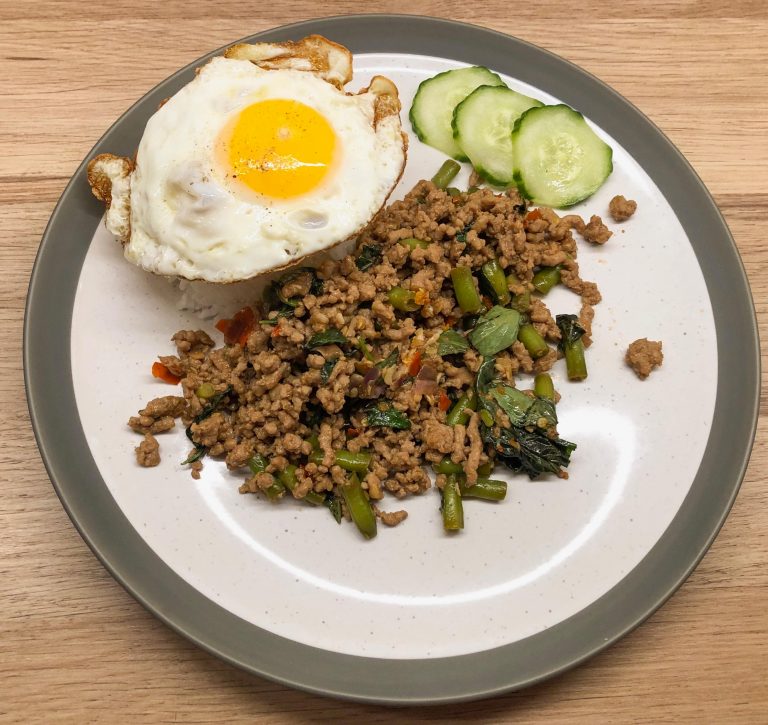 Chilli & Thai Basil Pork on a serving plate with jasmine rice and a crispy fried egg.