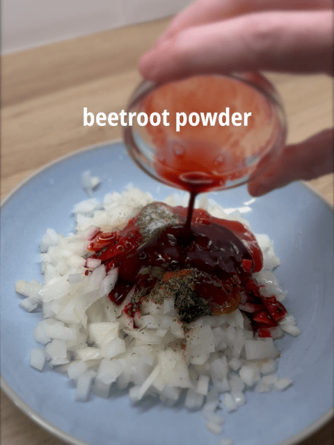 Beetroot powder mixed with water being added to the onions, providing deep red colour to the Glasgow style spiced onions mix.