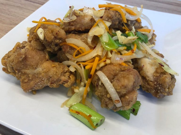 Chinese takeaway style salt & chilli chicken wings on a serving plate.