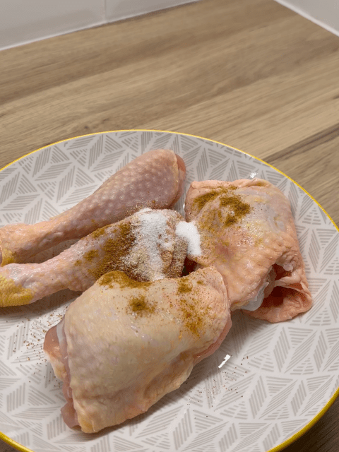 Bone in chicken thighs and drumsticks seasoned and ready to marinate before being coated in flour and air fried.