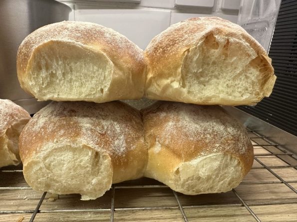 Crispy Scottish morning rolls cooling on a wire rack.