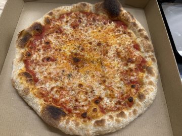 A pizza with tomato easy pizza sauce and mozzarella cheese.