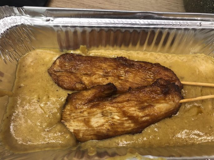 Satay Sauce (Chinese Takeaway Style) Chinese takeaway style chicken satay skewers in a foil tray with satay sauce.