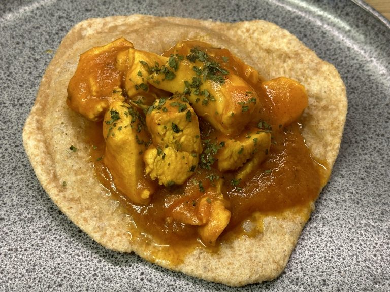 Indian takeaway style sweet and sour chicken puri on a serving plate.