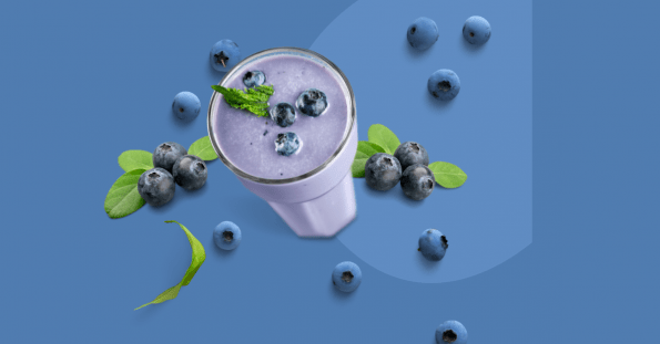 A blueberry smoothie in a tall glass.