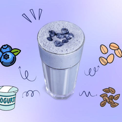 A blueberry smoothie in a tall serving glass.