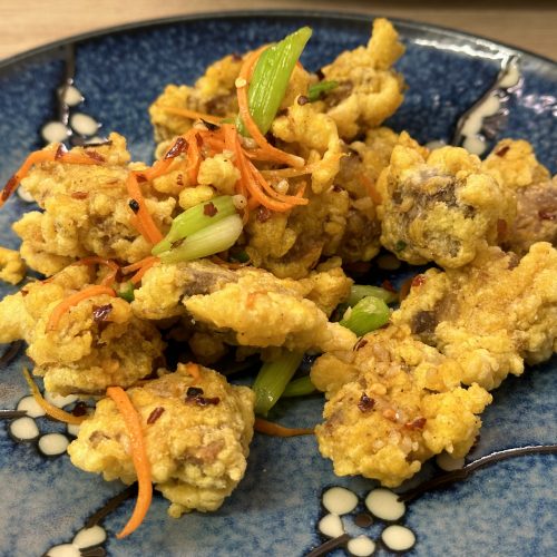Salt and chilli crispy pork on a serving plate.