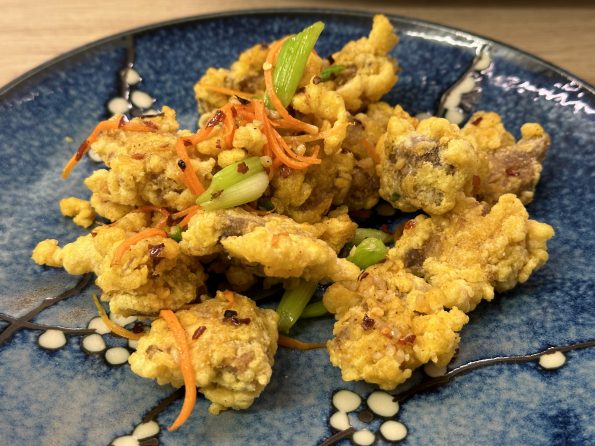 Salt and chilli crispy pork on a serving plate.