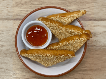 Chinese takeaway style sesame prawn toast with sweet chilli sauce on the side.