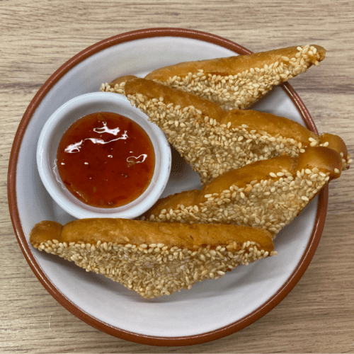 Chinese takeaway style sesame prawn toast with sweet chilli sauce on the side.