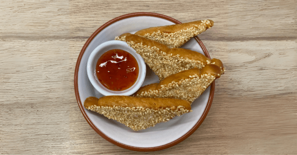 Chinese takeaway style sesame prawn toast with sweet chilli sauce on the side.