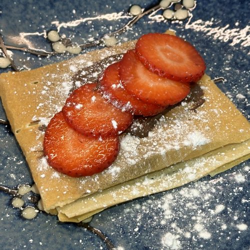 Street Food Style Strawberry Chocolate Crepes on a serving plate.