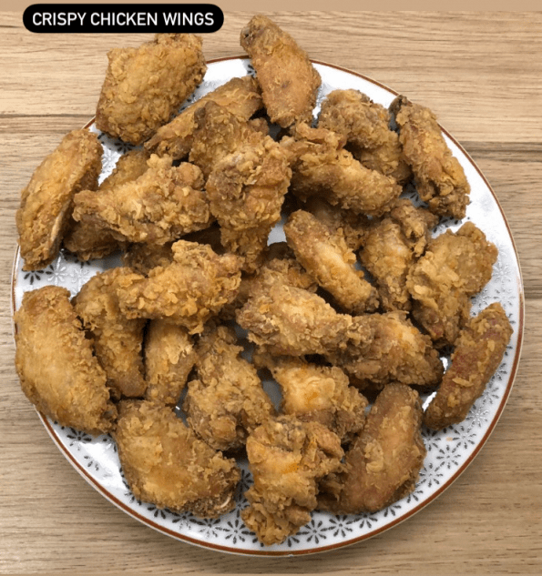 Chinese takeaway style chicken wings on a serving plate.