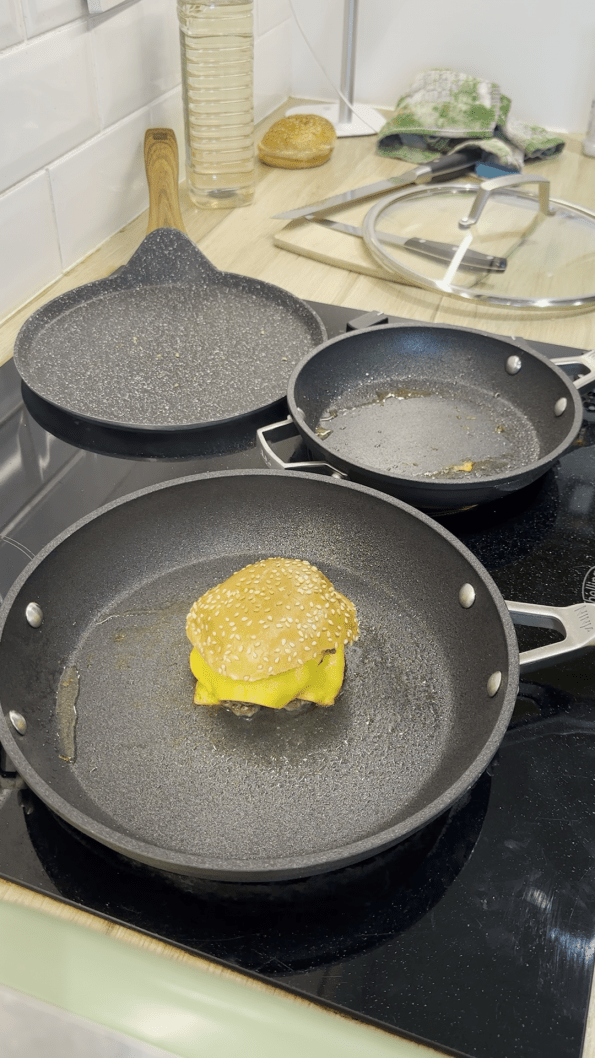 Double smash burger assembled with burger bun on top.