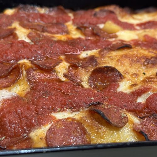 Detroit style pepperoni pizza in a Detroit style baking pan.