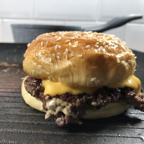 A Double smash burger with cheese ready to serve.