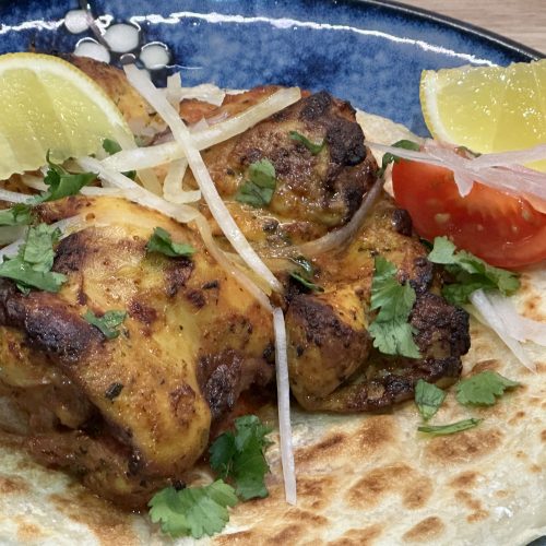 Indian Takeaway Style Air Fryer Tandoori Chicken Thighs on a Crispy Paratha.