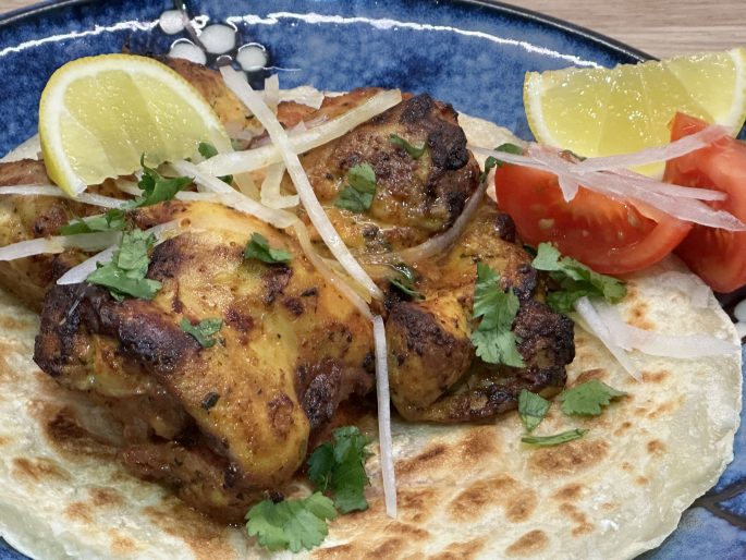Indian Takeaway Style Air Fryer Tandoori Chicken Thighs on a Crispy Paratha.