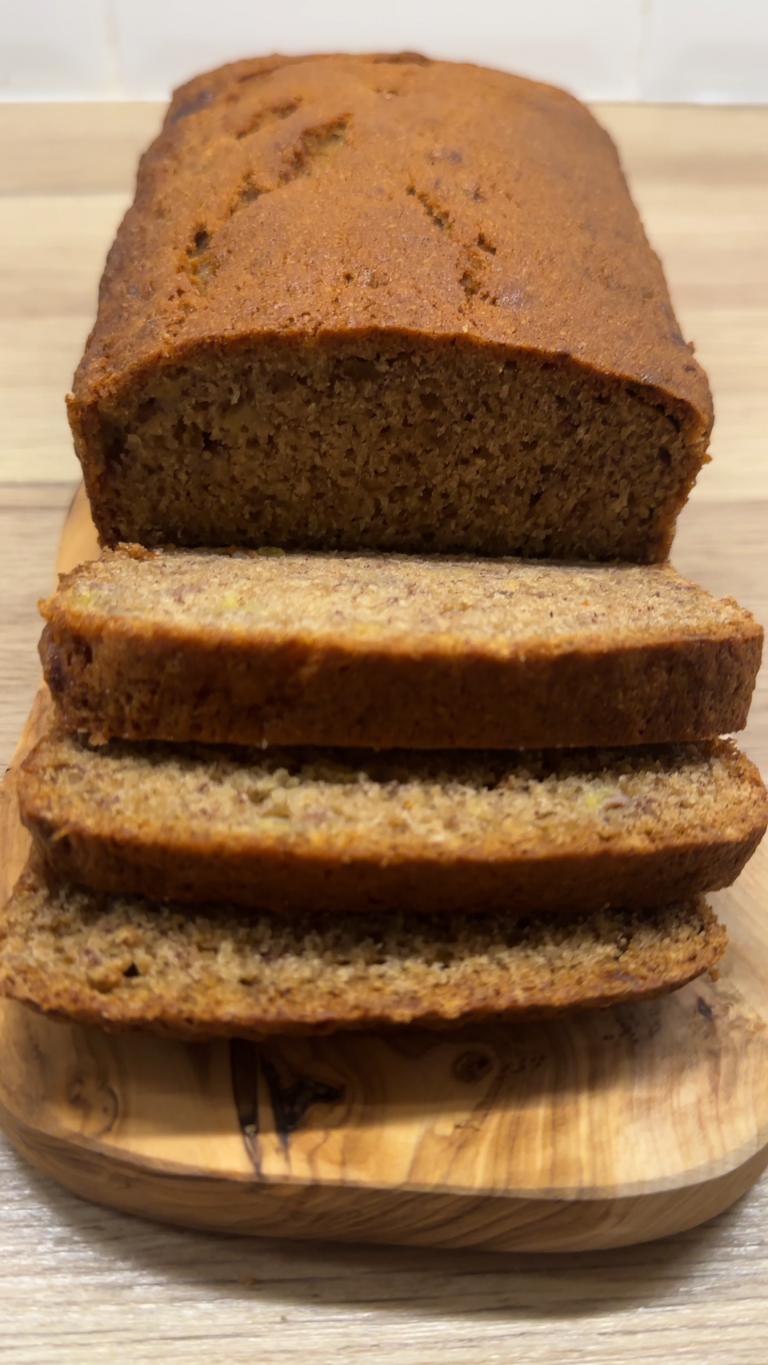 Sliced banana bread on a serving board.